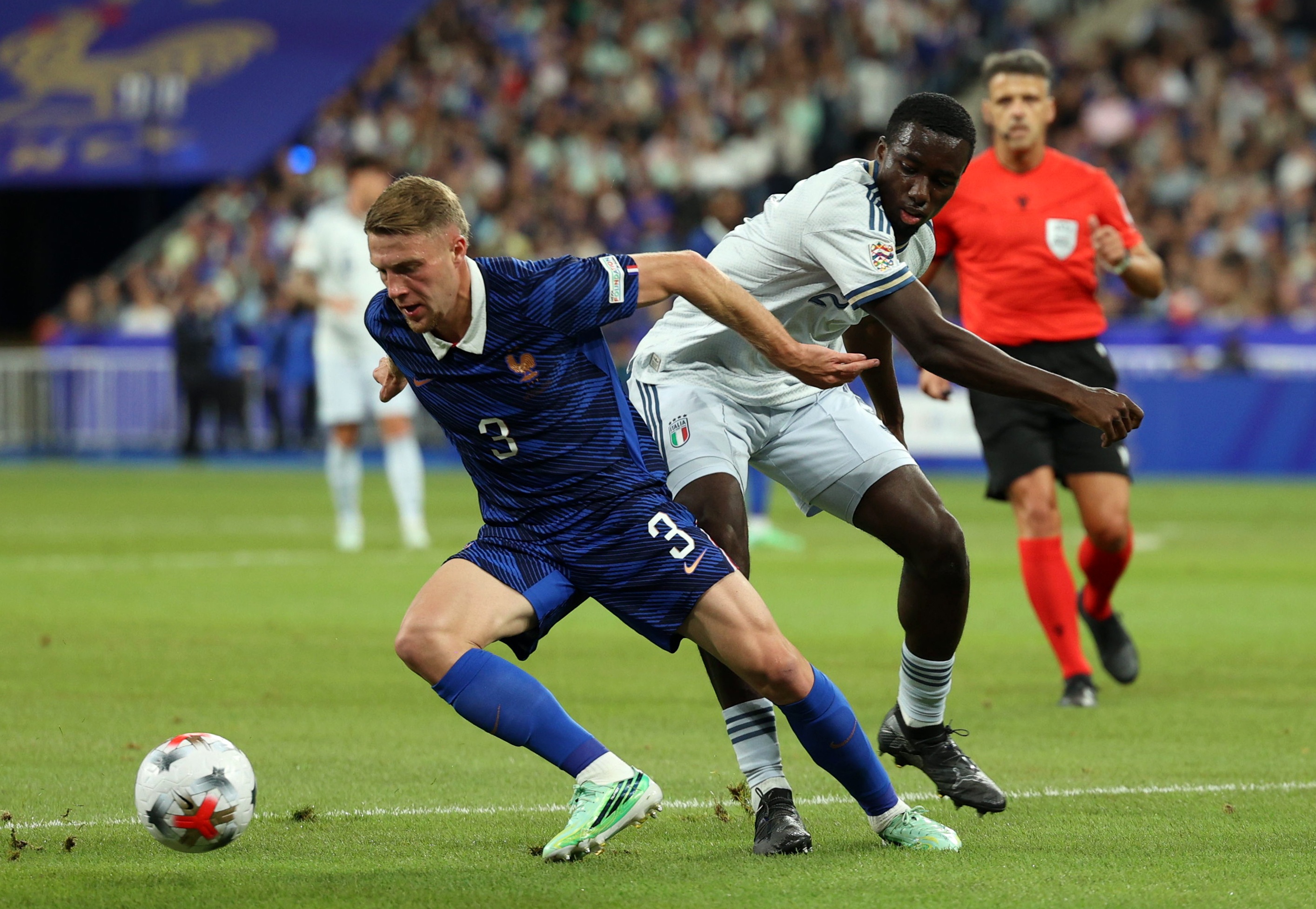 Liverpool transfer target Adrien Truffert dribbles and holds of Italy star Michael Kayode.