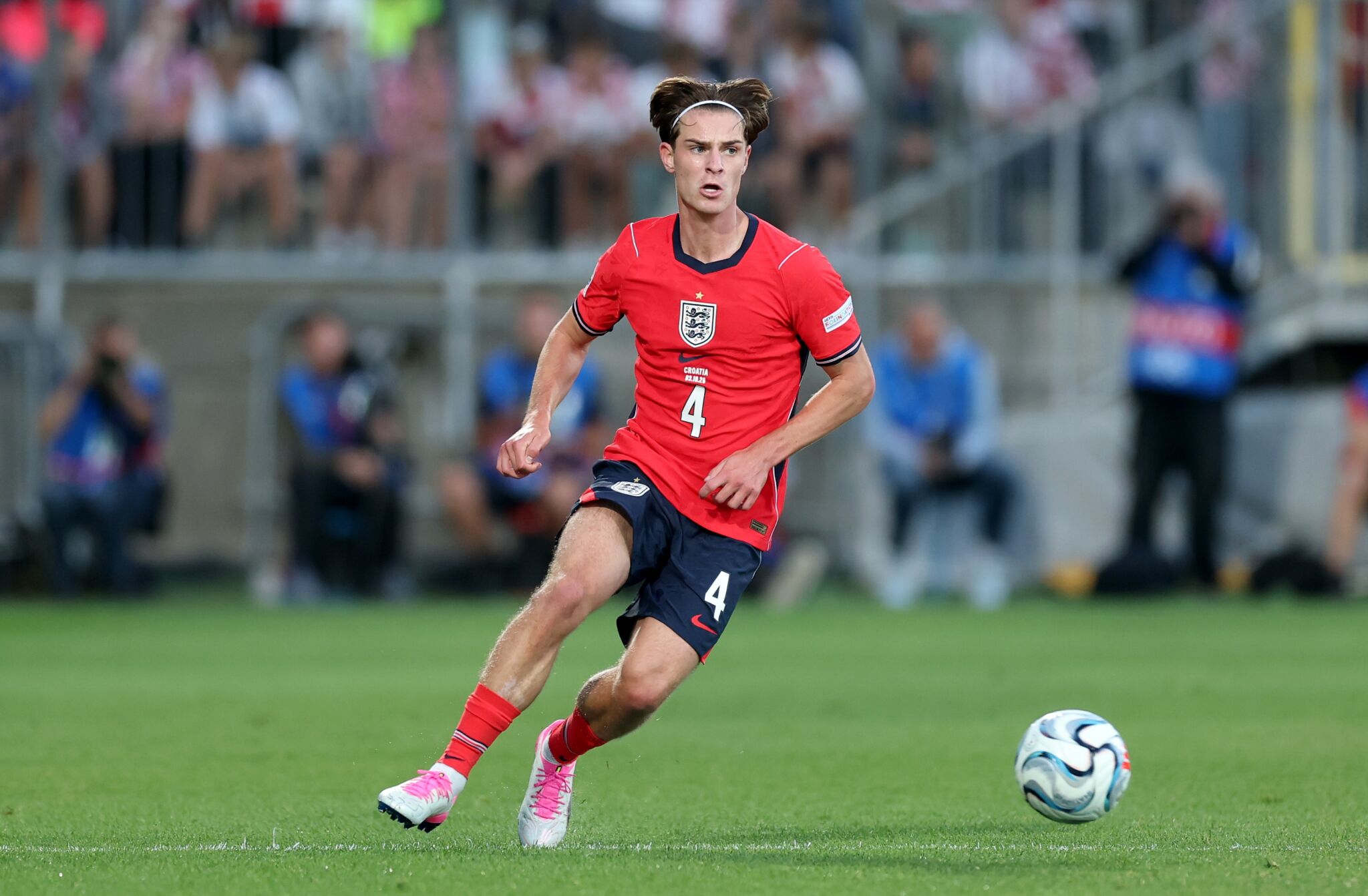 Alex Scott dribbles on the ball for England.