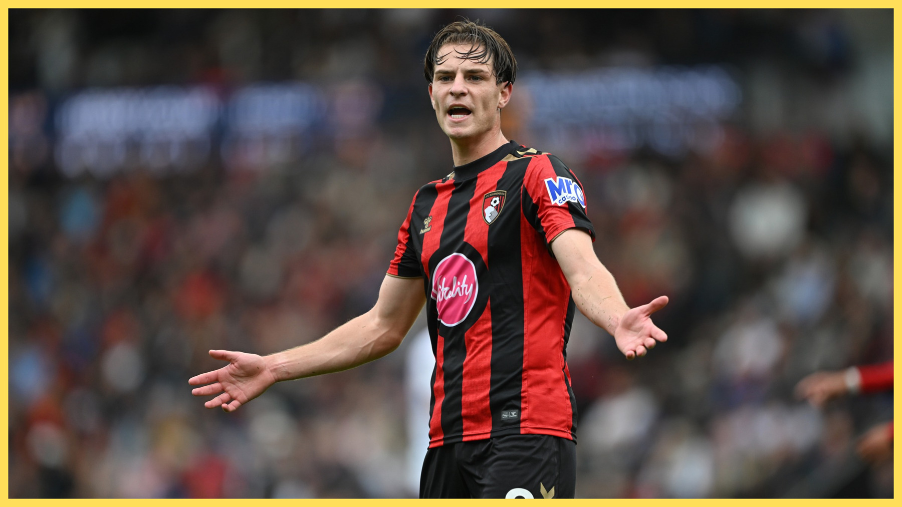 Alex Scott holds his arms out wide during Bournemouth game.