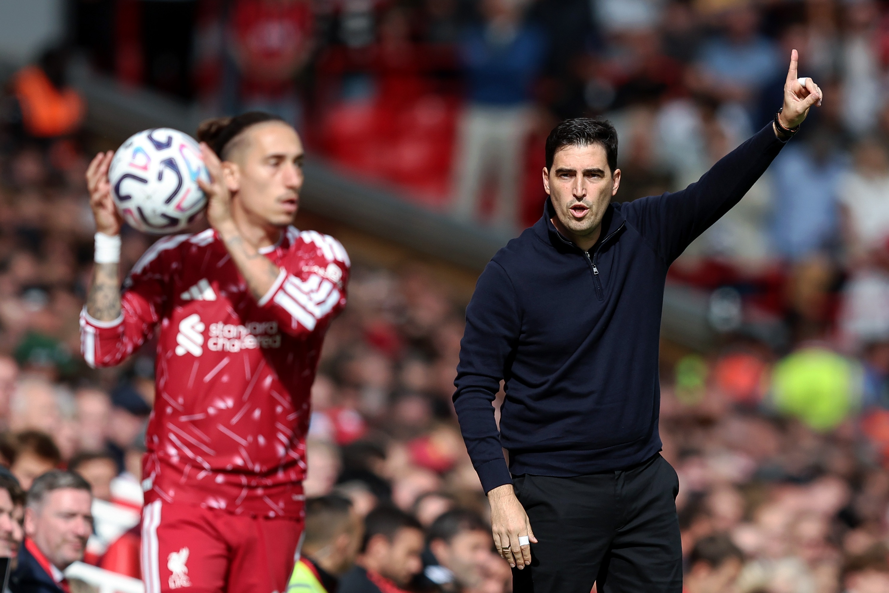 Andoni Iraola directs instructions at Liverpool fullback Kostas Tsimikas.