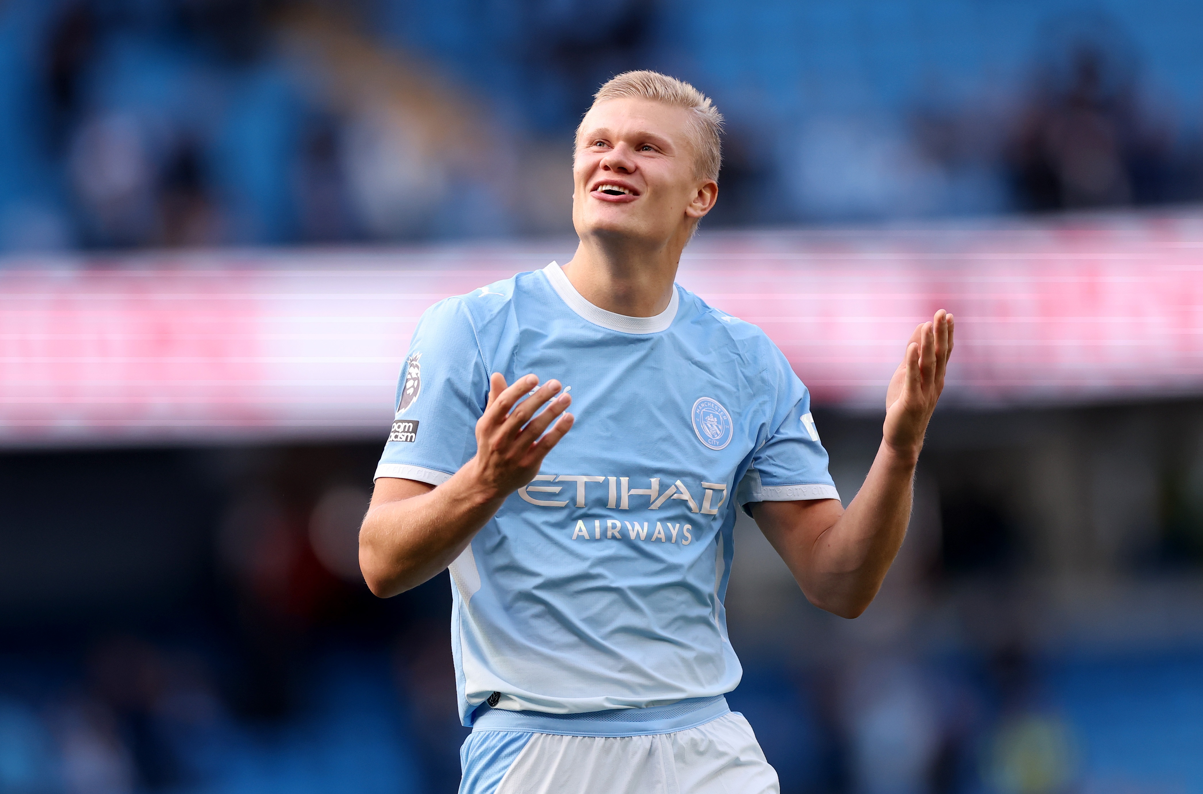 Erling Haaland lifts up his hands during Man City game.