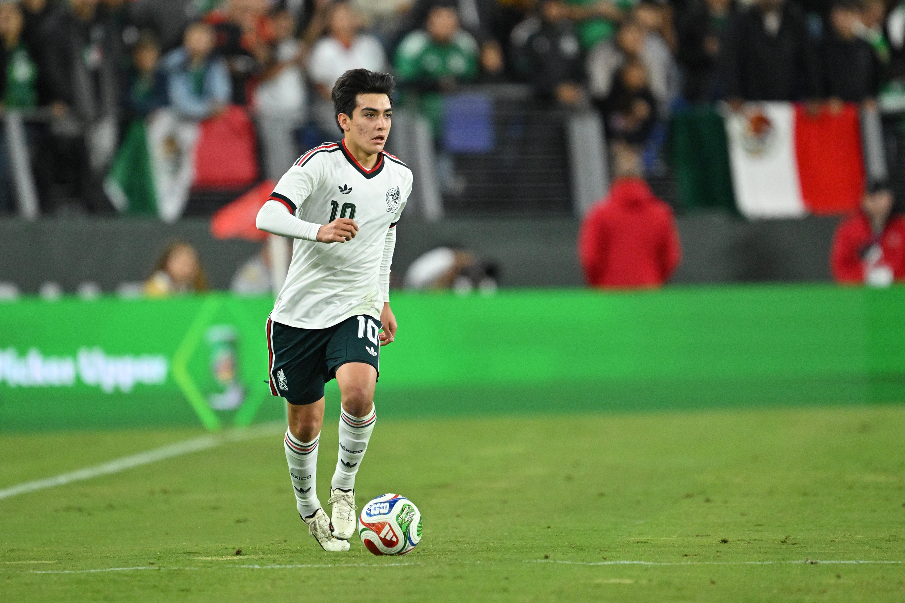 Liverpool transfer target Gilberto Mora dribbles on the ball for Mexico.