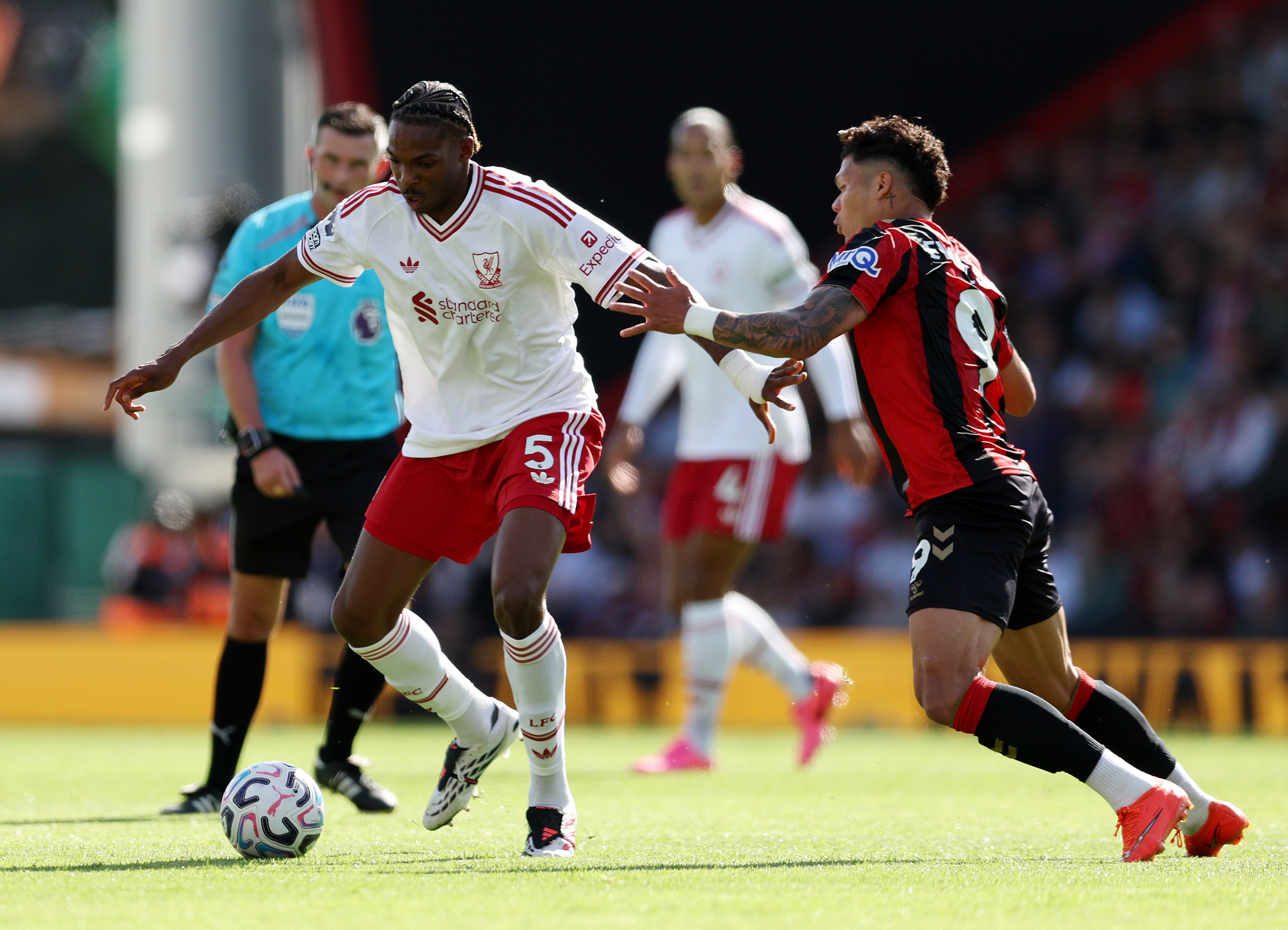Liverpool defender Jeremy Jacquet holds off Bournemouth's Evanilson.