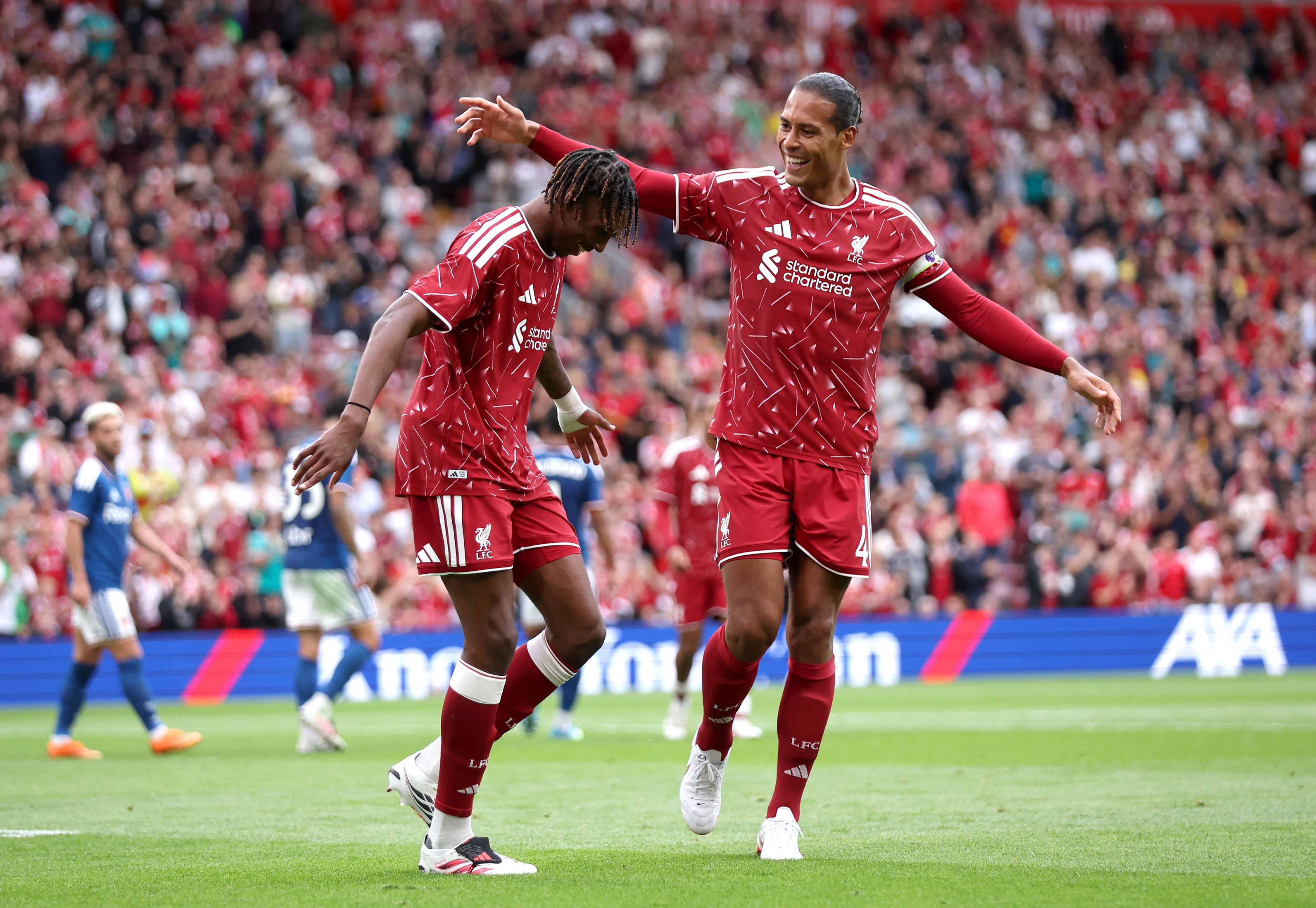 Jeremy Jacquet celebrates with Liverpool centre-back partner Virgil van Dijk.