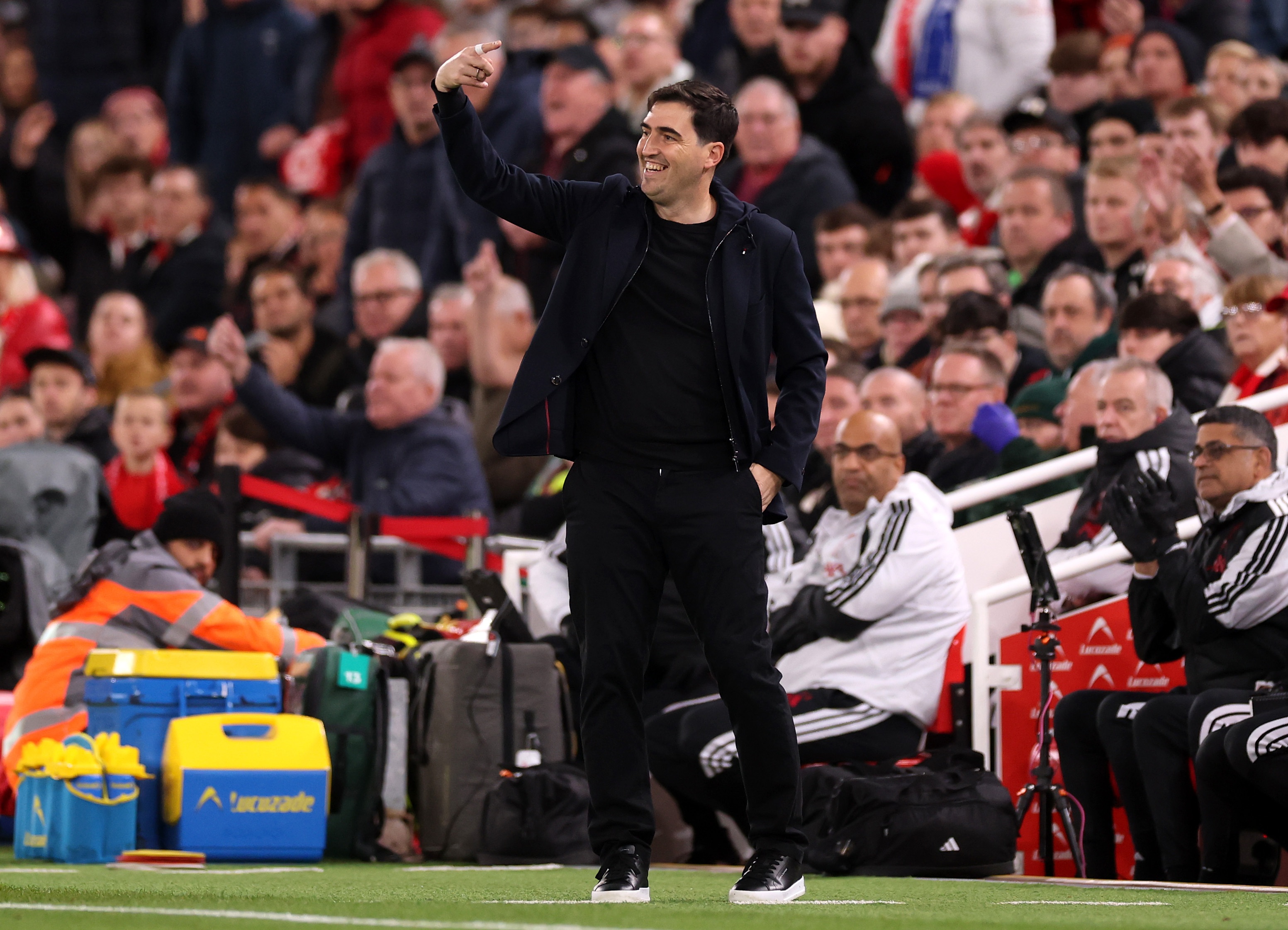 Andoni Iraola raises his arm during Liverpool game.