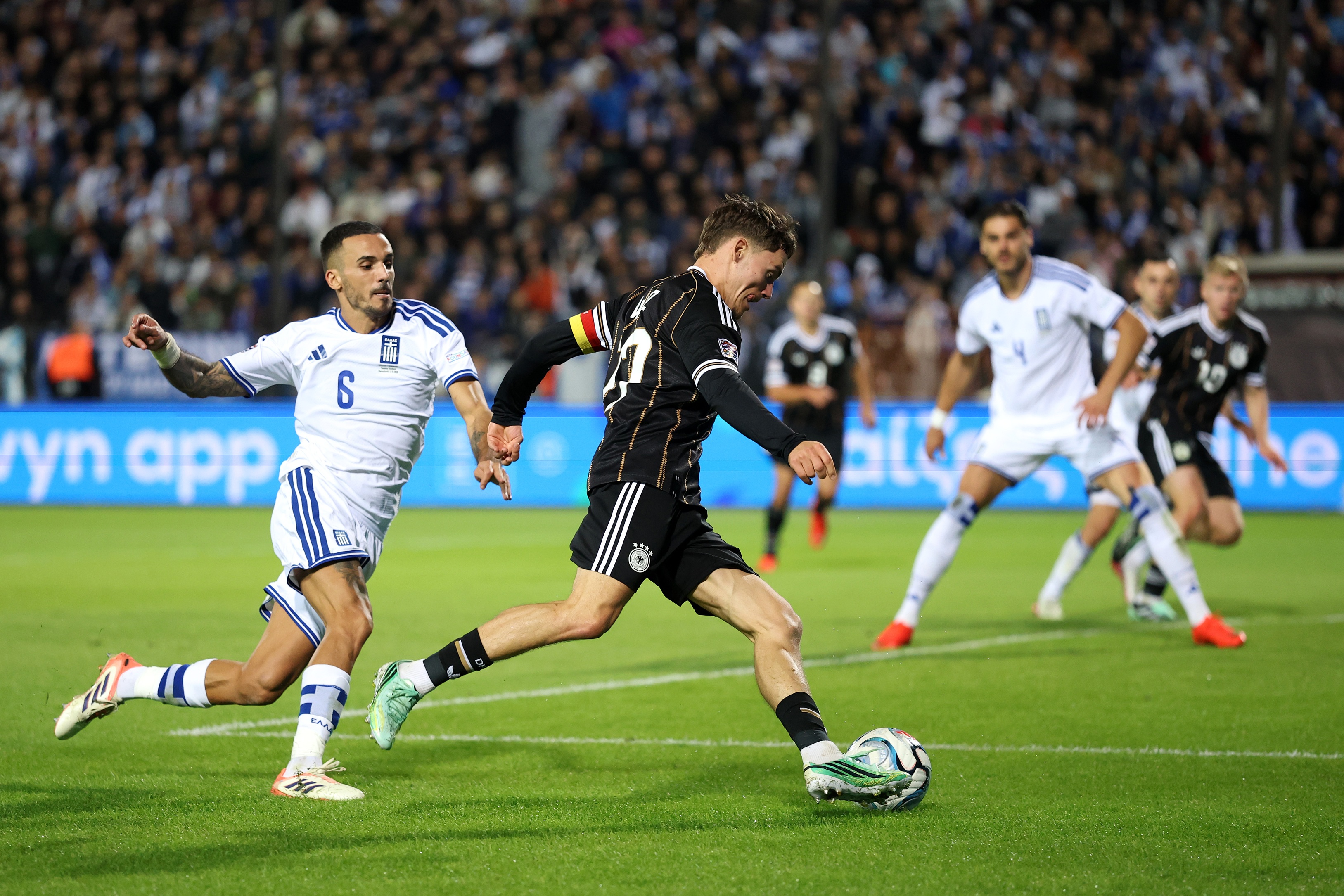 Liverpool midfielder Florian Wirtz dribbles past a Greece player.