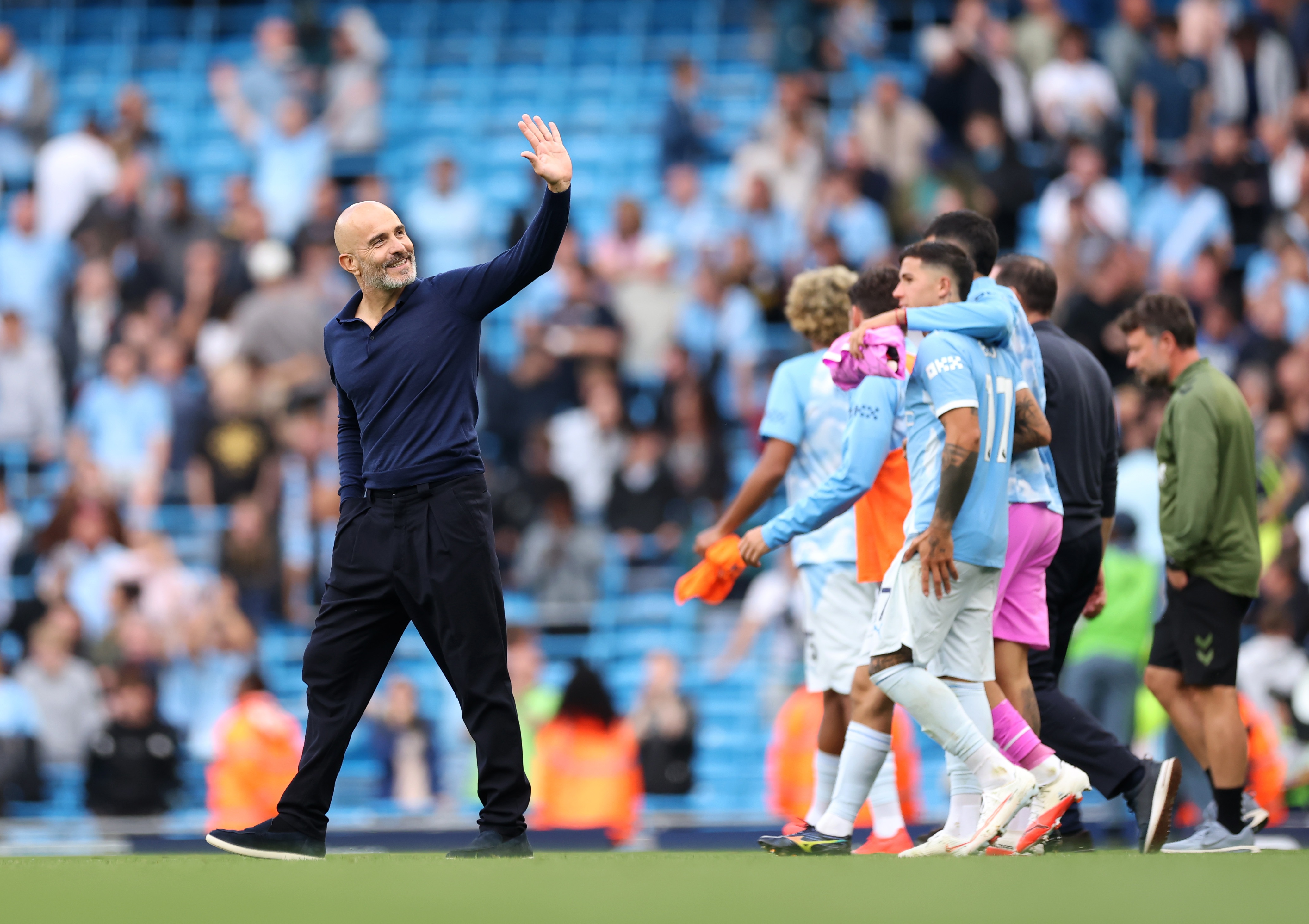Enzo Maresca waves at Manchester City fans.