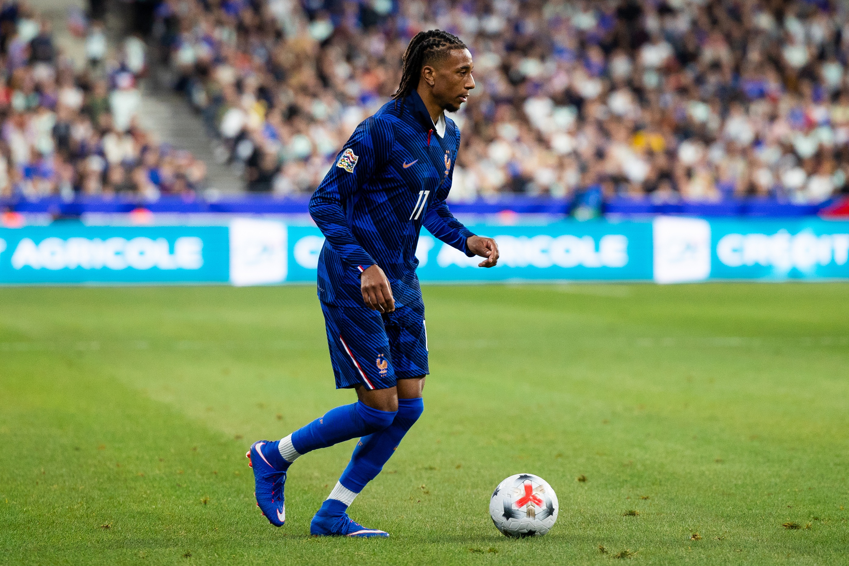 Liverpool transfer target Michael Olise dribbles on the ball during France game.