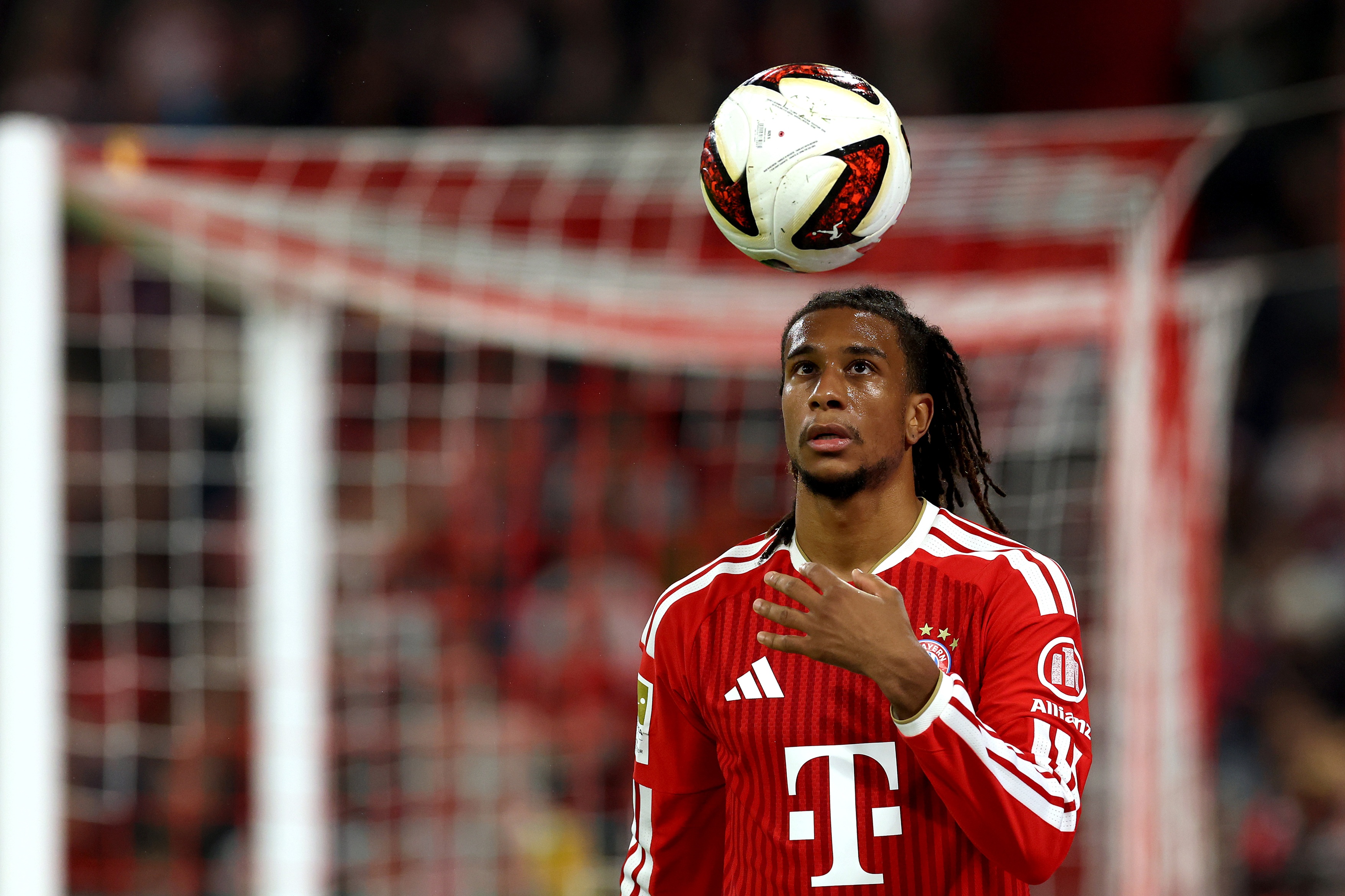 Liverpool transfer target Michael Olise throws a football up in the air.