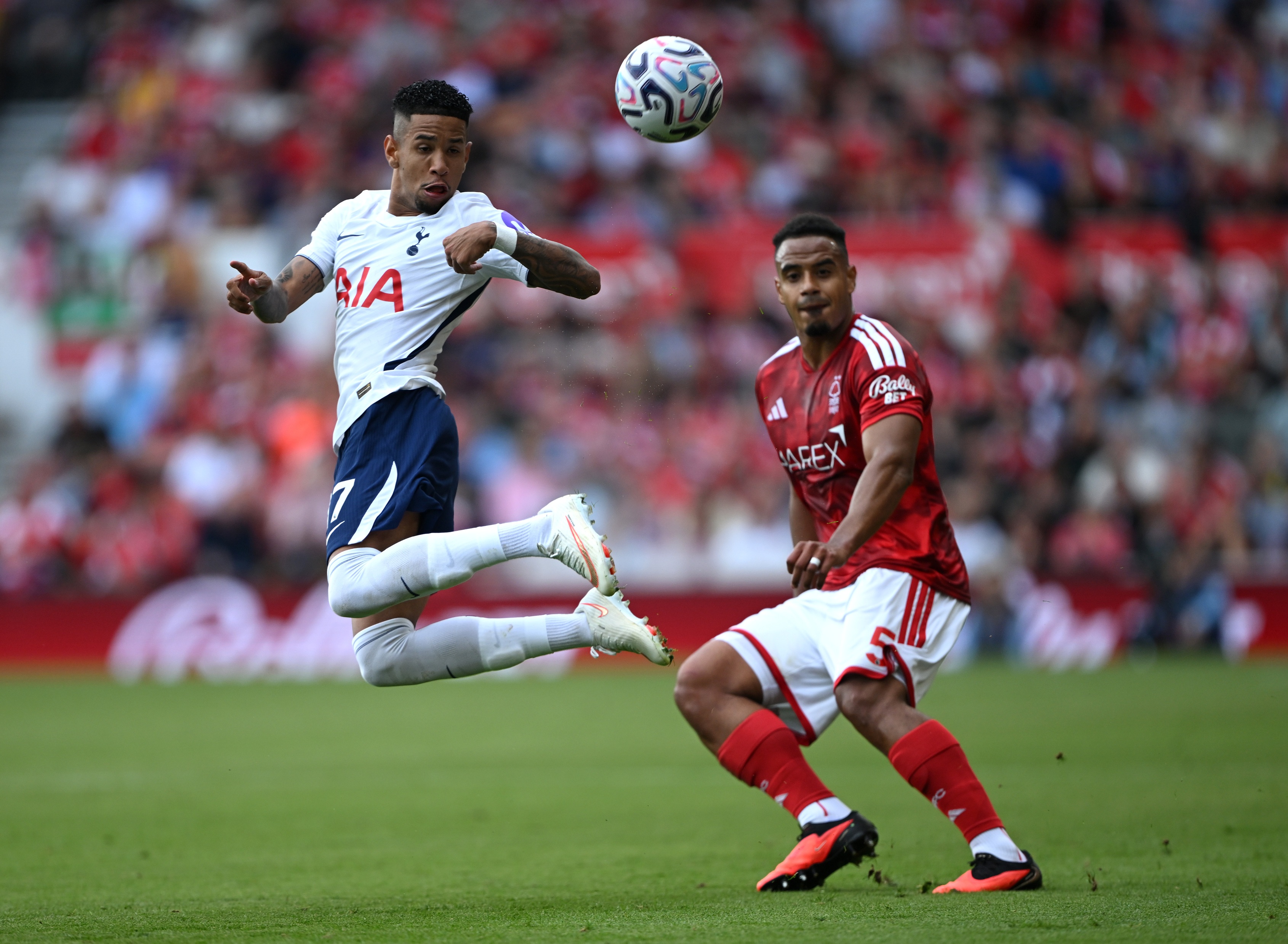 Liverpool transfer target Murillo competes with Savio for possession of the ball.