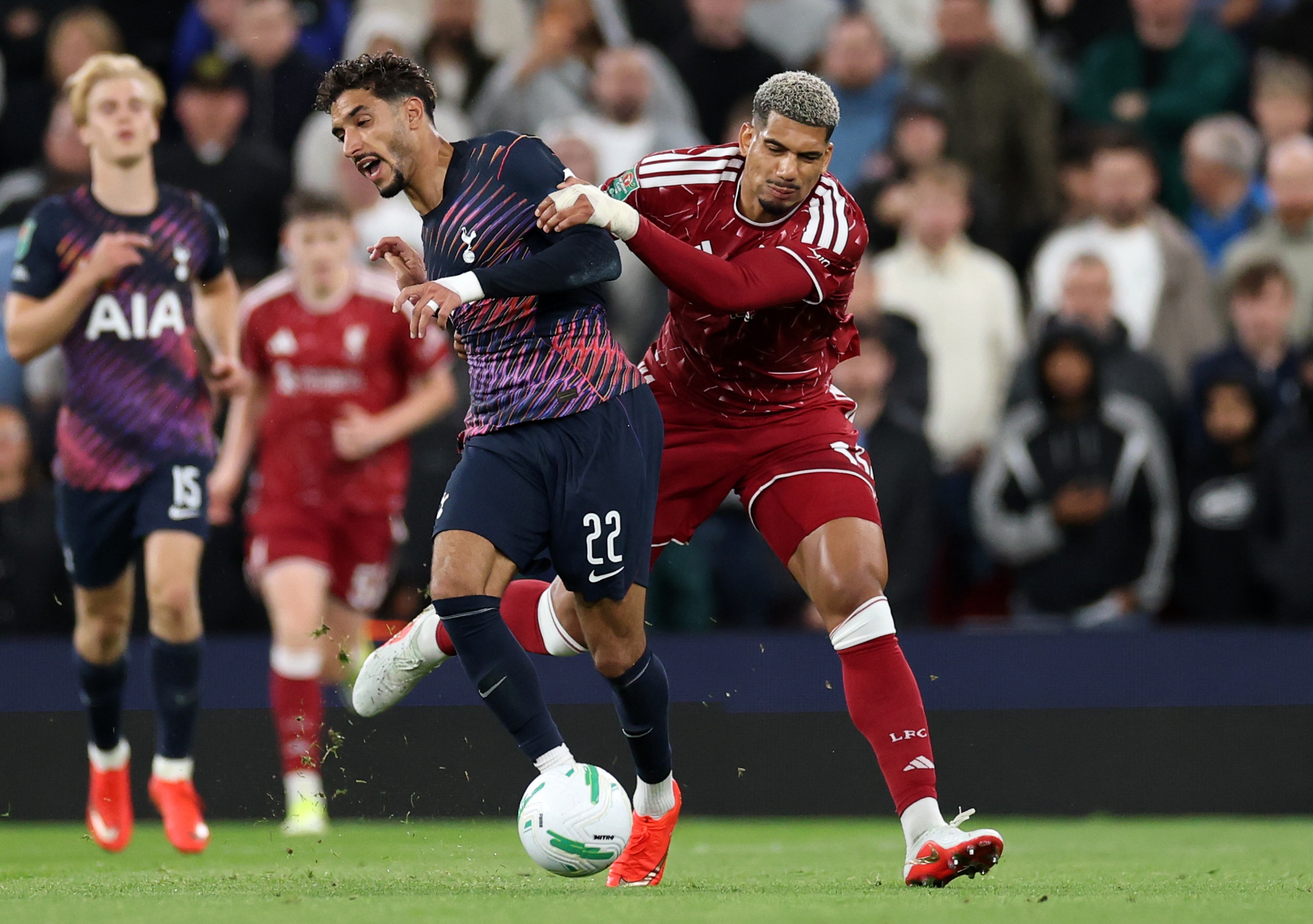 Liverpool centre-back Ronald Araujo grapples with Tottenham forward Omar Marmoush.
