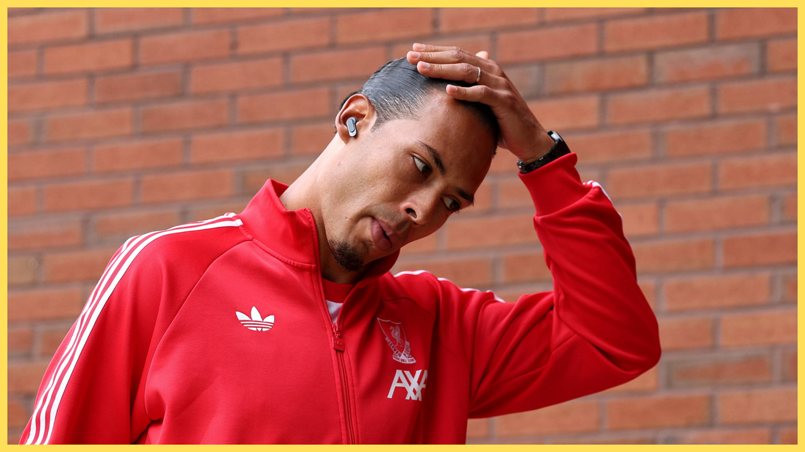 Liverpool centre-back Virgil van Dijk rubs the top of his head.