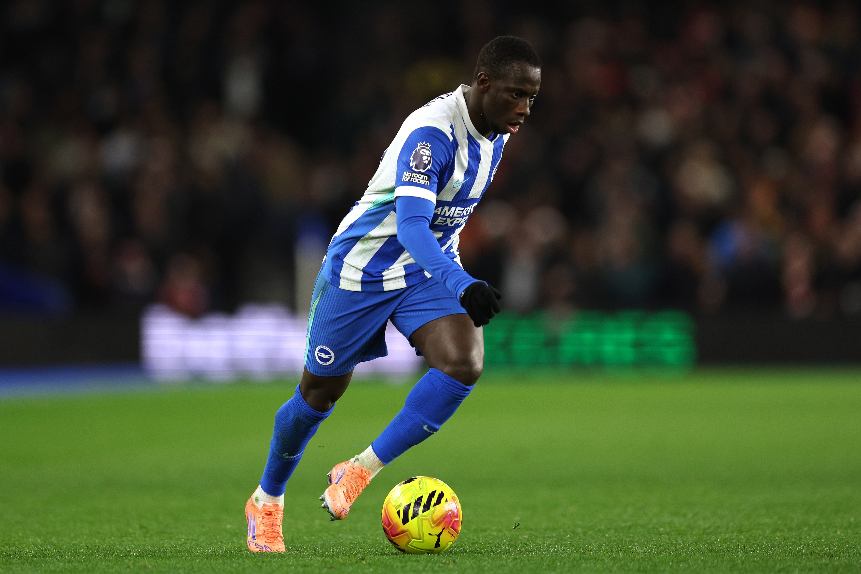 Liverpool transfer target Yankuba Minteh dribbles on the ball for Brighton.