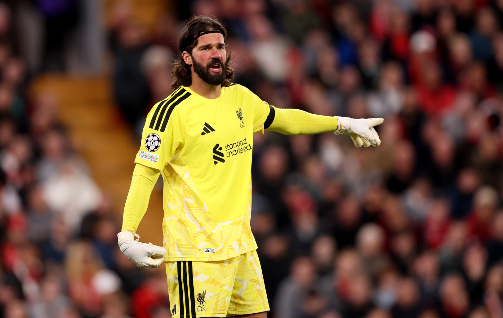 Alisson Becker gestures towards his Liverpool teammates