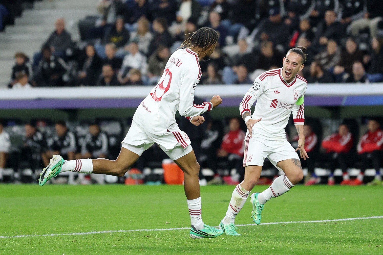 Bradley Barcola celebrates with Kostas Tsimikas after scoring for Liverpool