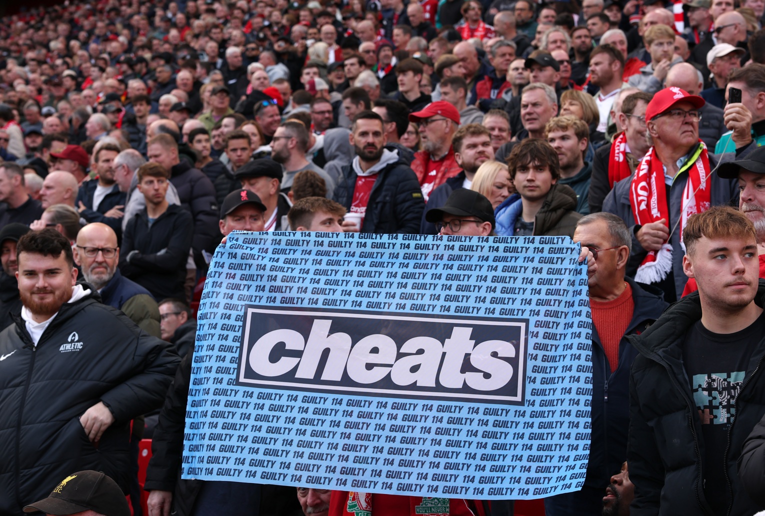 Liverpool fans display a banner decrying Man City's multiple rule breaches of financial rules