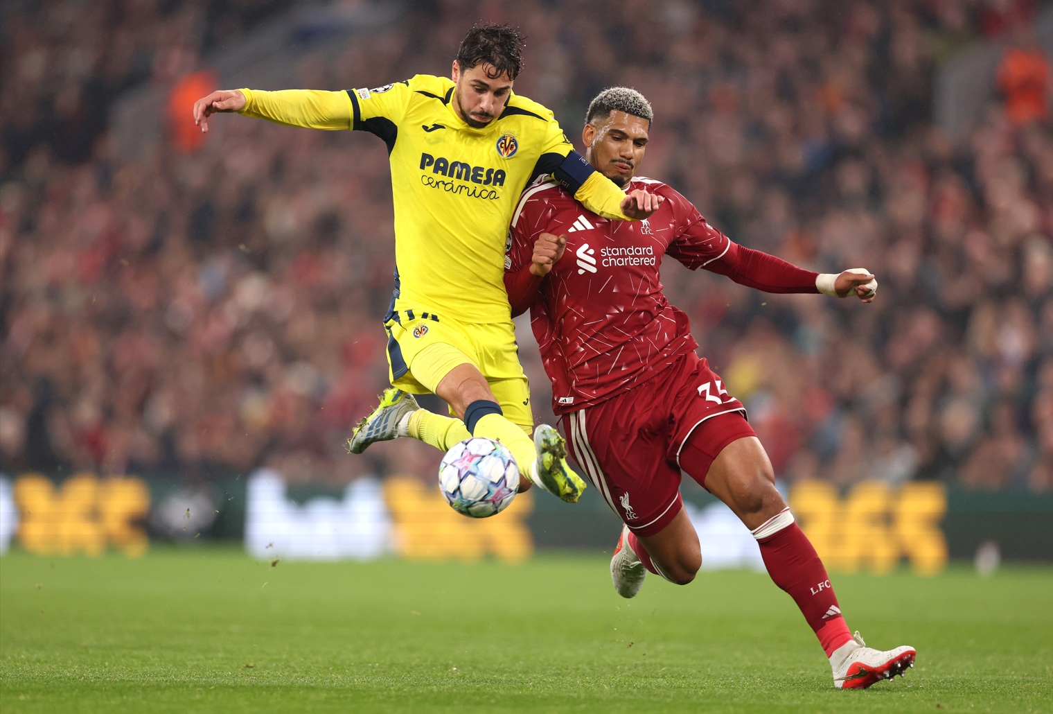 Santi Comesana and Ronald Araujo battle for possession at Anfield