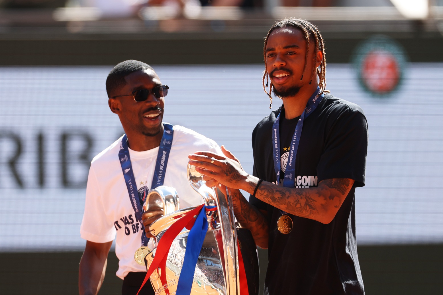 Ousmane Dembele and Bradley Barcola display the Champions League trophy at the French Open