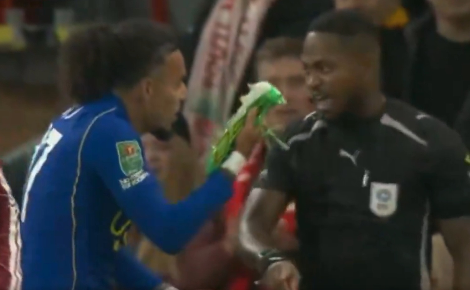Malo Gusto waves his boot at the assistant referee