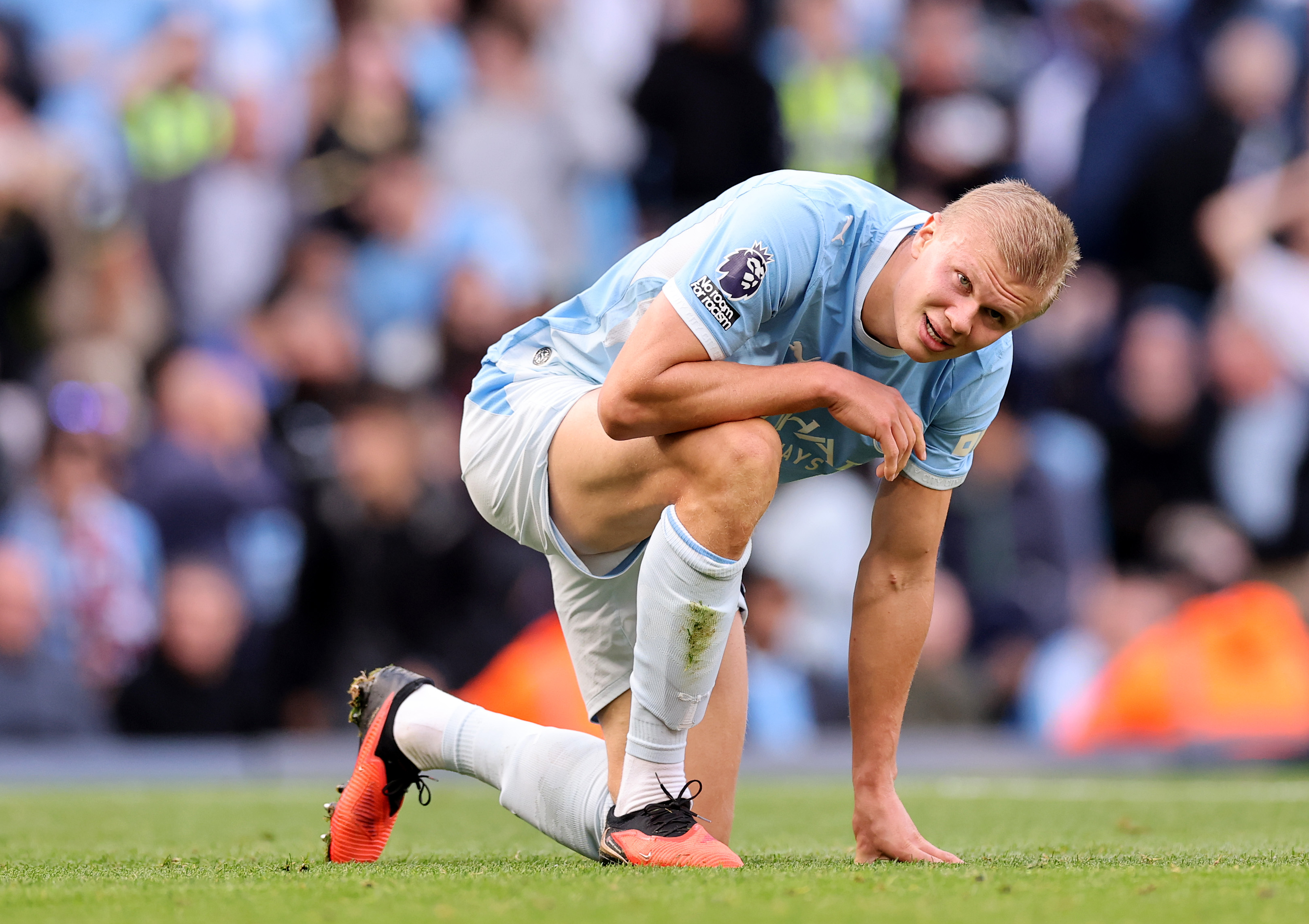 Erling Haaland genuflects during a match for Manchester City