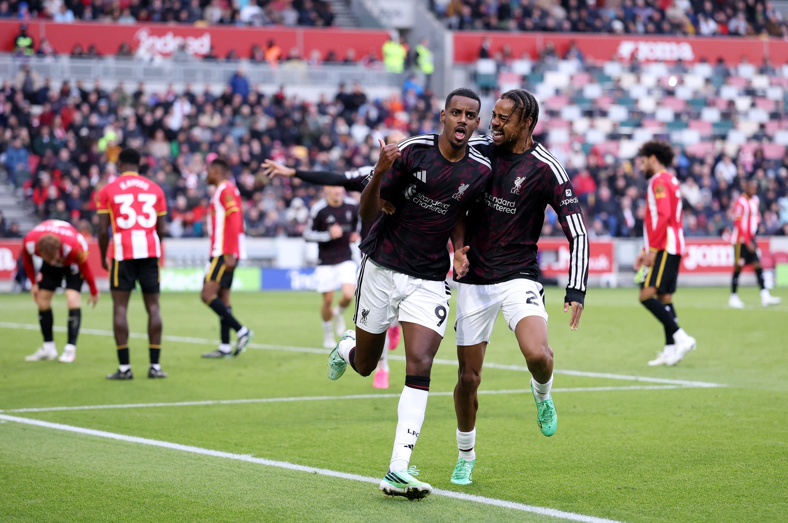 Alexander Isak and Bradley Barcola celebrate the Swede's winning goal against Brentford