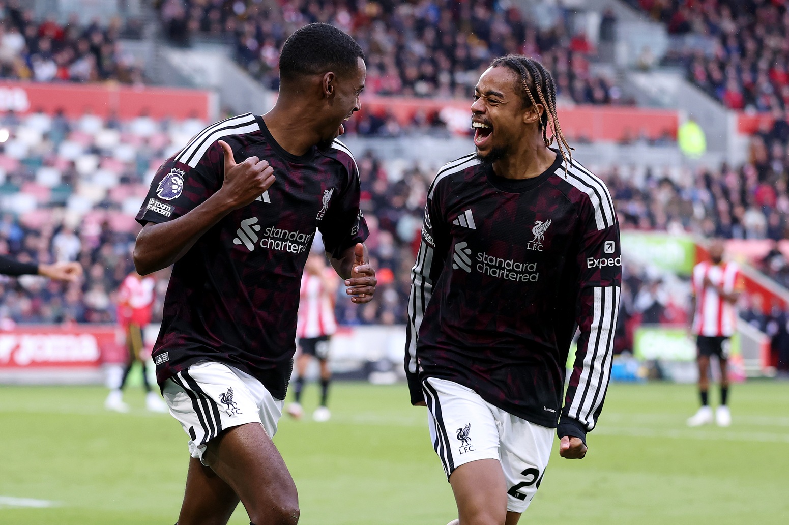 Alexander Isak and Bradley Barcola celebrate after the Swede's winner for Liverpool against Brentford