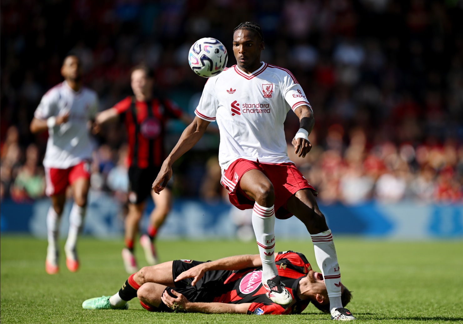 Jeremy Jacquet wins the ball as Adrien Truffert lies on the ground