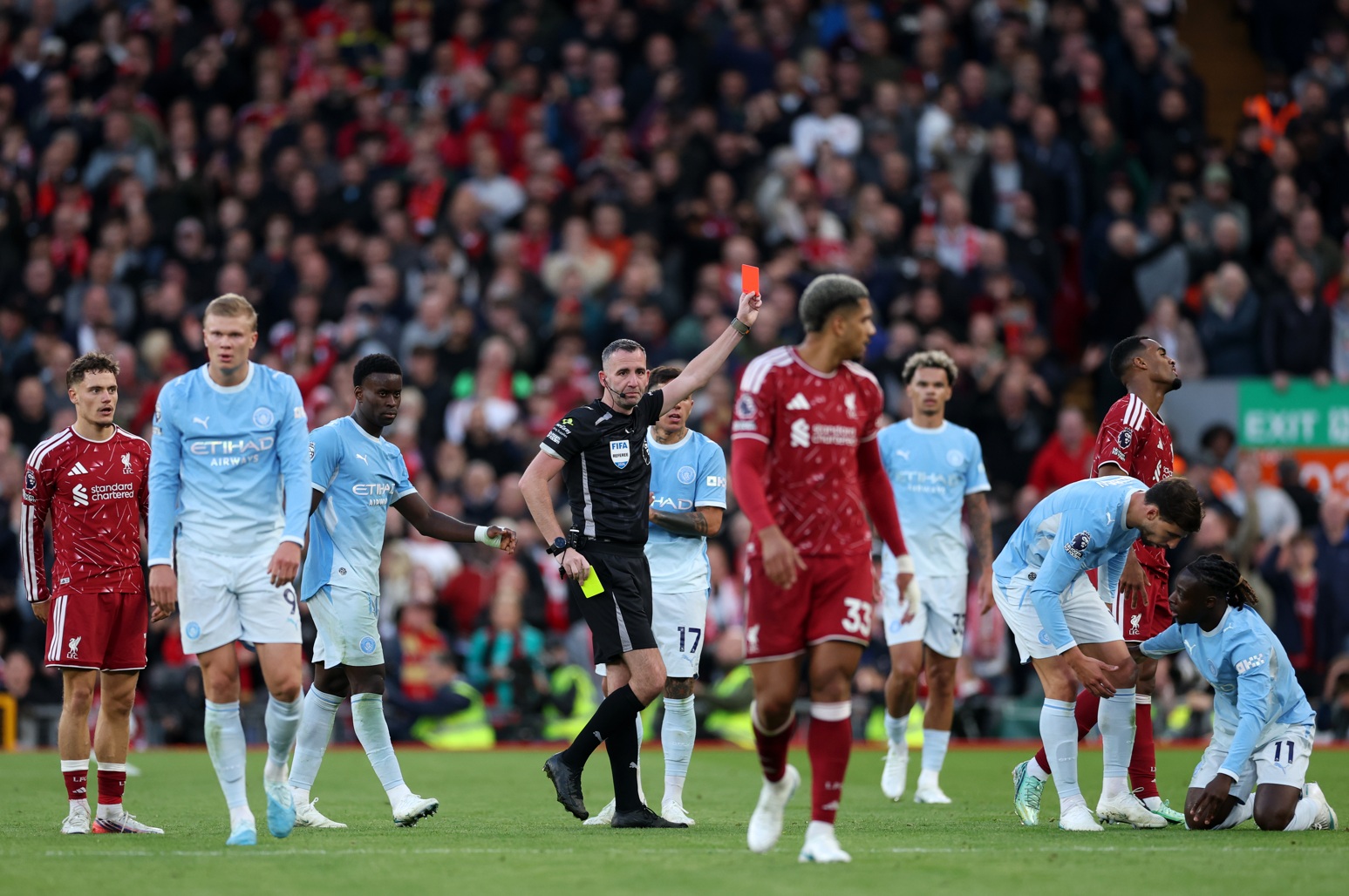 Chris Kavanagh shows a red card to Ryan Gravenberch at Anfield