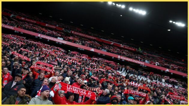 Liverpool fans hold up scarves prior to a match at Anfield