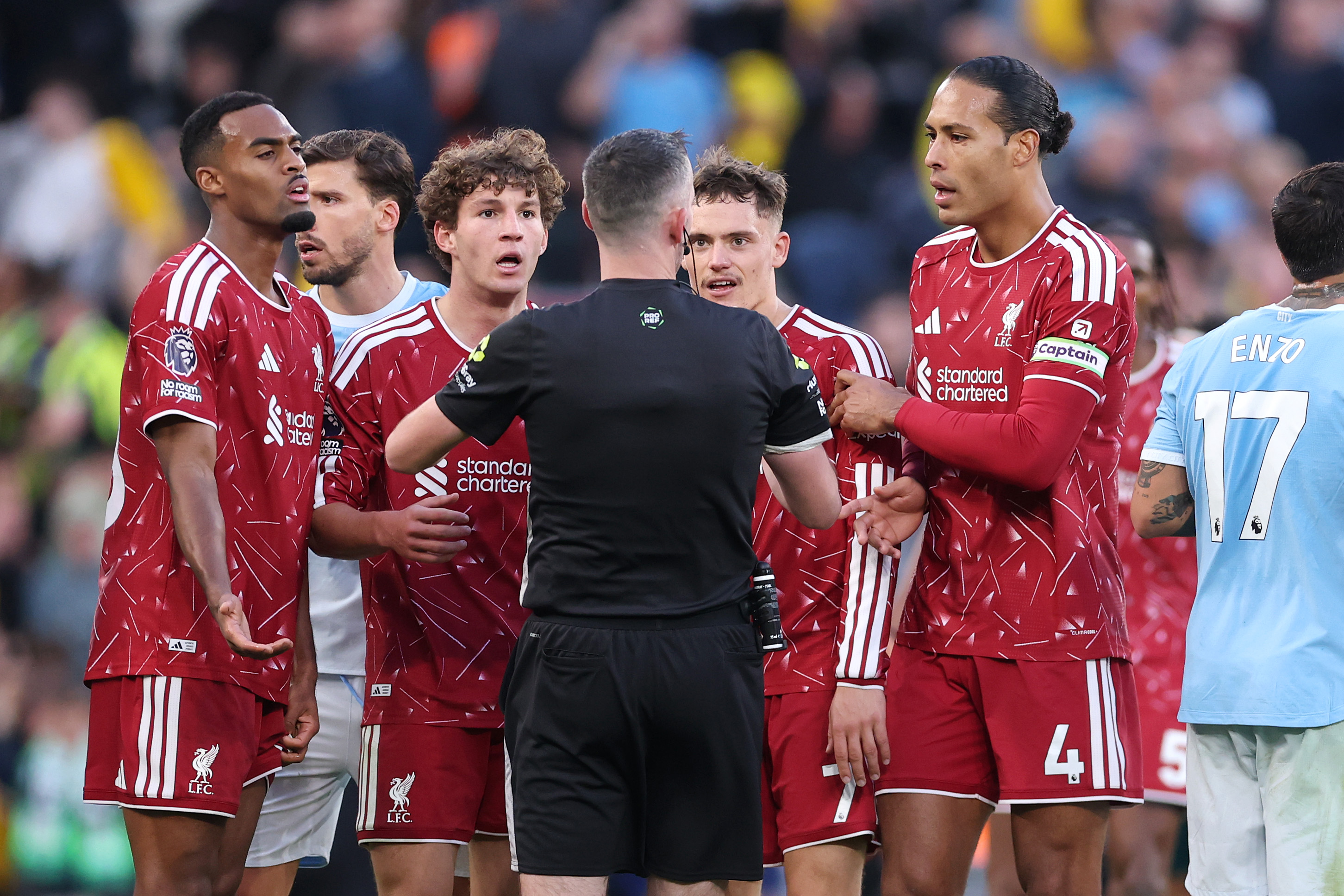 Liverpool players surround Chris Kavanagh after the red card for Ryan Gravenberch