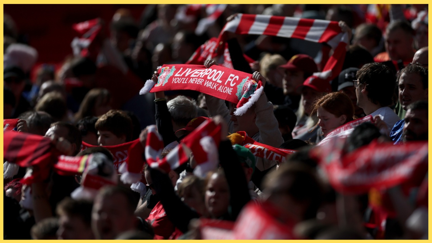 A supporter holds up a Liverpool scarf prior to kick-off