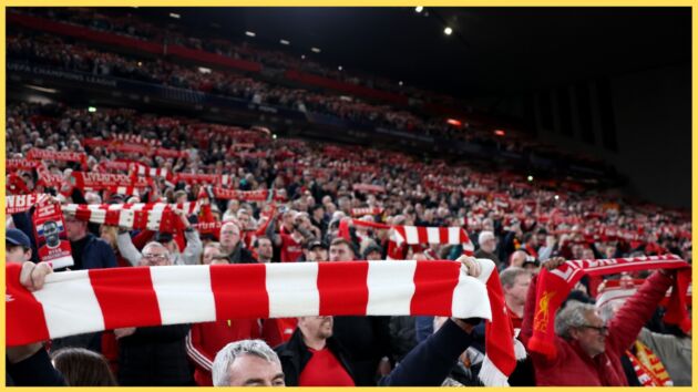 Liverpool fans at Anfield hold up scarves prior to kick-off