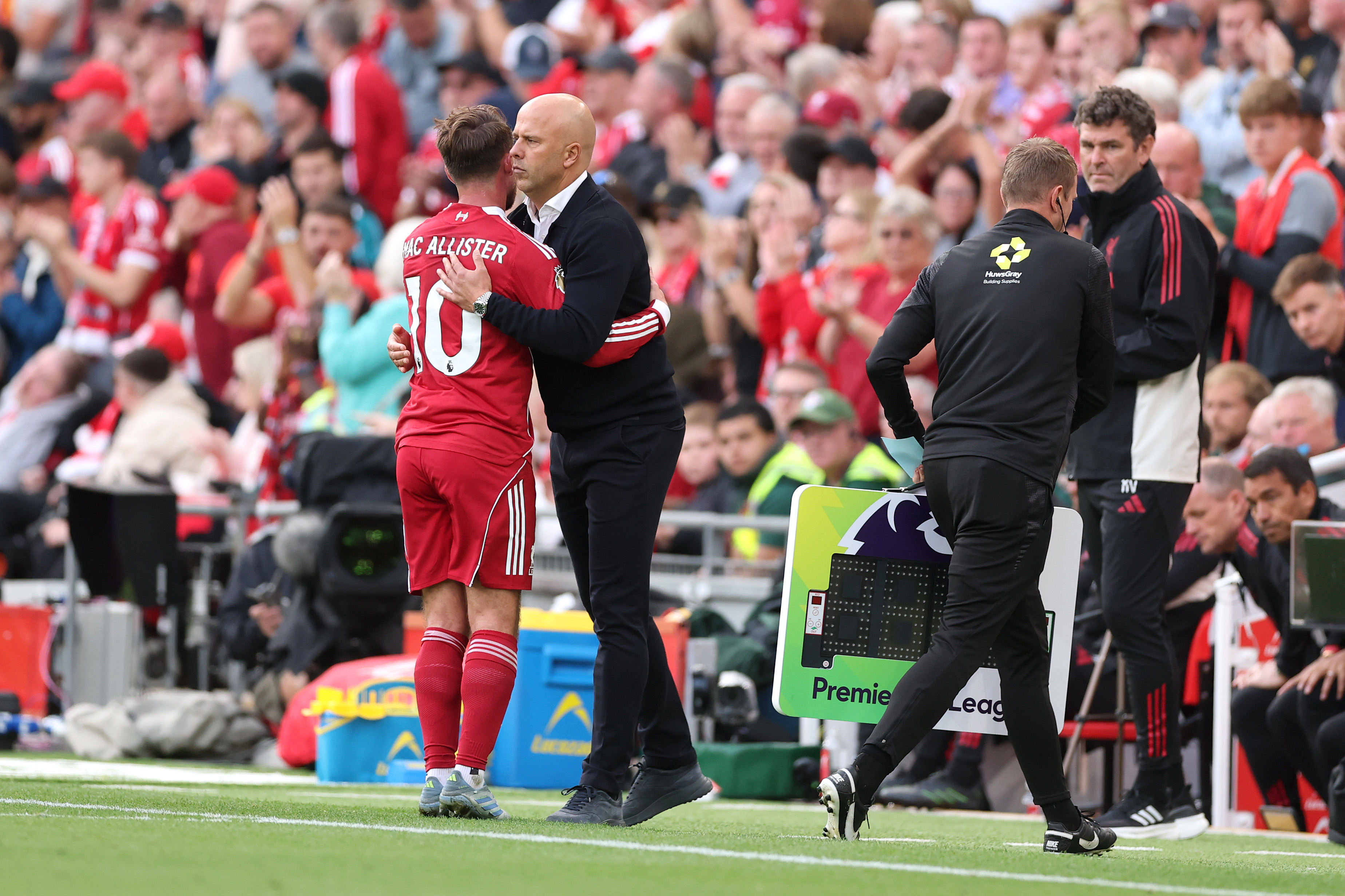 Arne Slot greets Alexis Mac Allister during a match at Anfield