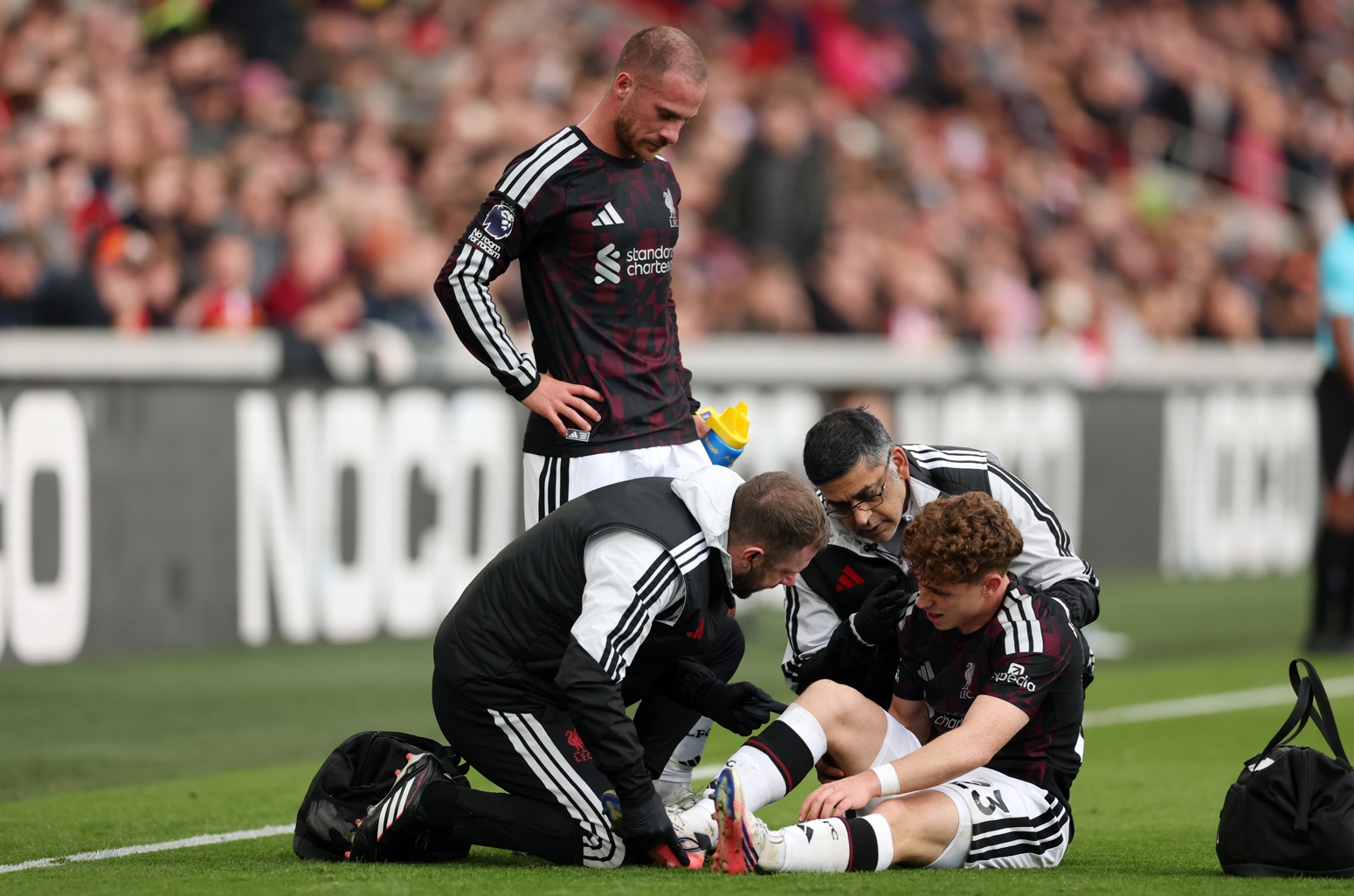 Victor Munoz receives treatment on the pitch during Liverpool's win over Brentford