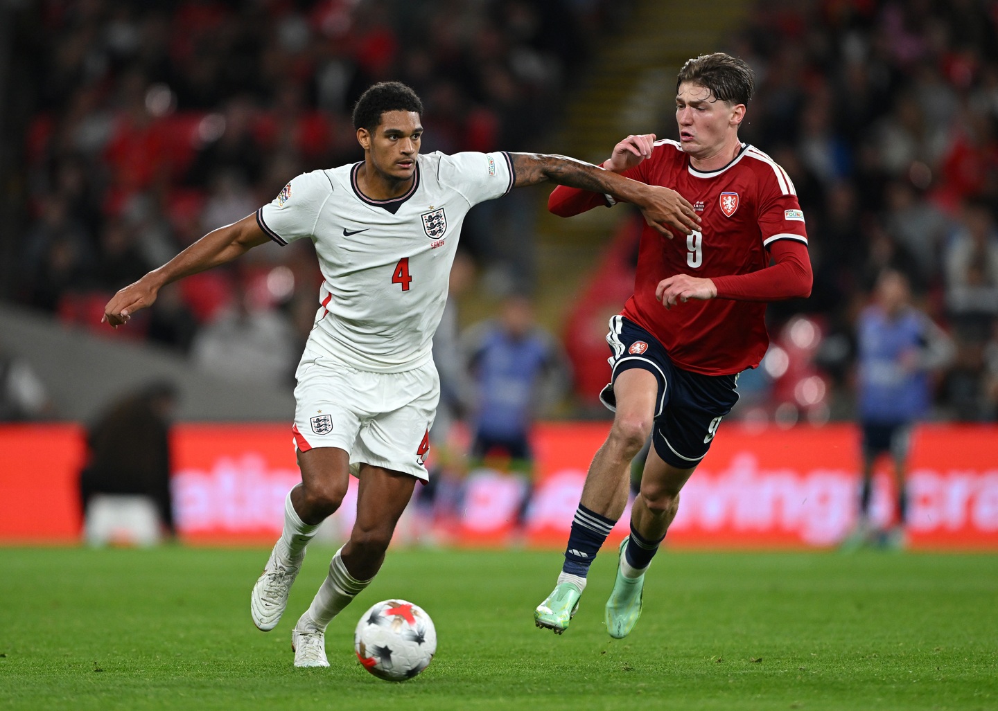 Jarell Quansah holds off the close attention of Ryan Naderi
