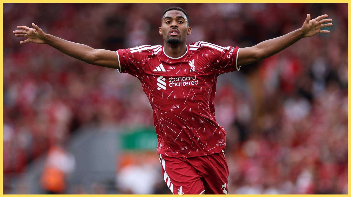 Ryan Gravenberch holds his arms aloft during a match at Anfield