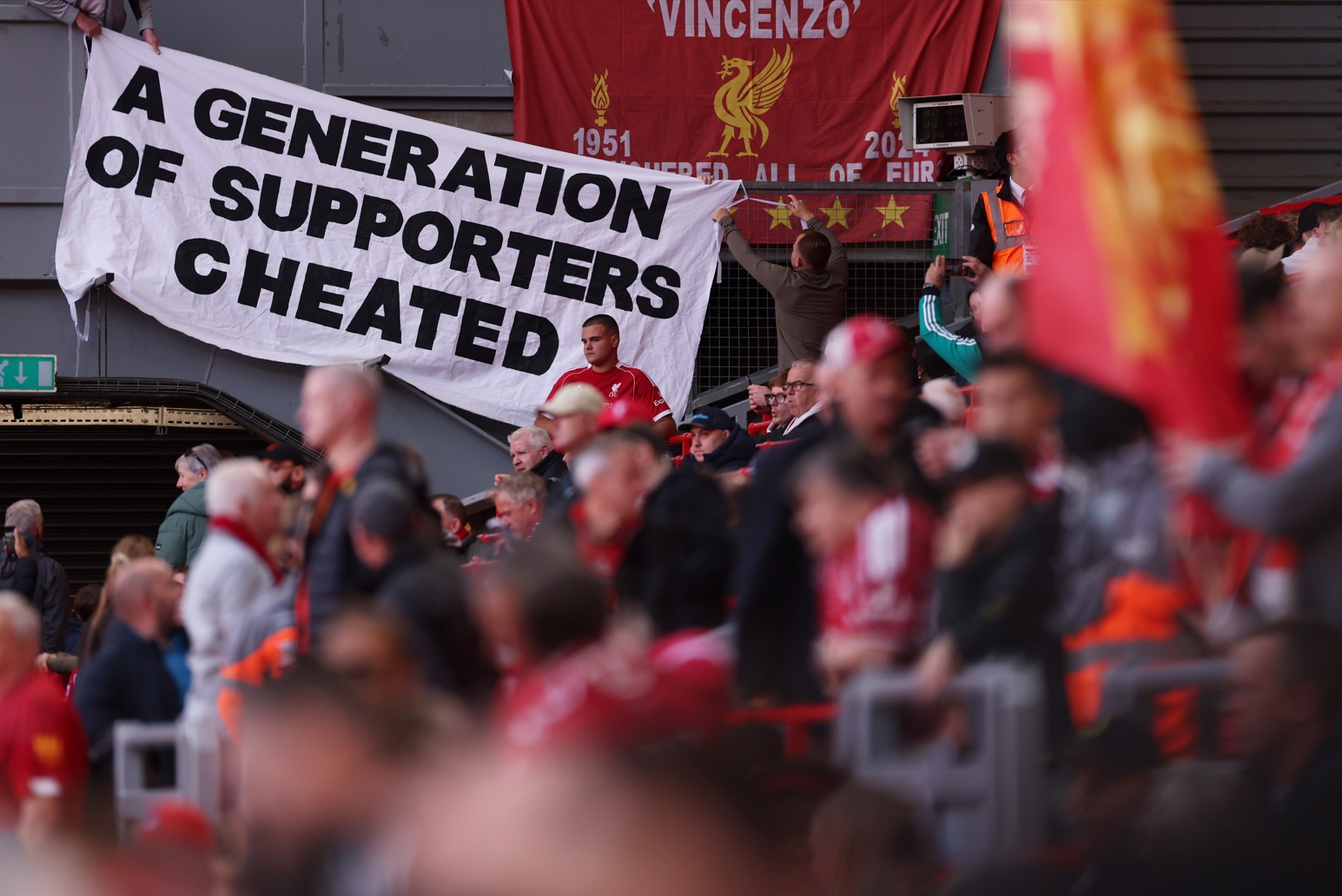 Liverpool fans display a banner which reads 'A generation of supporters cheated' in anger at Man City's financial rule-breaking