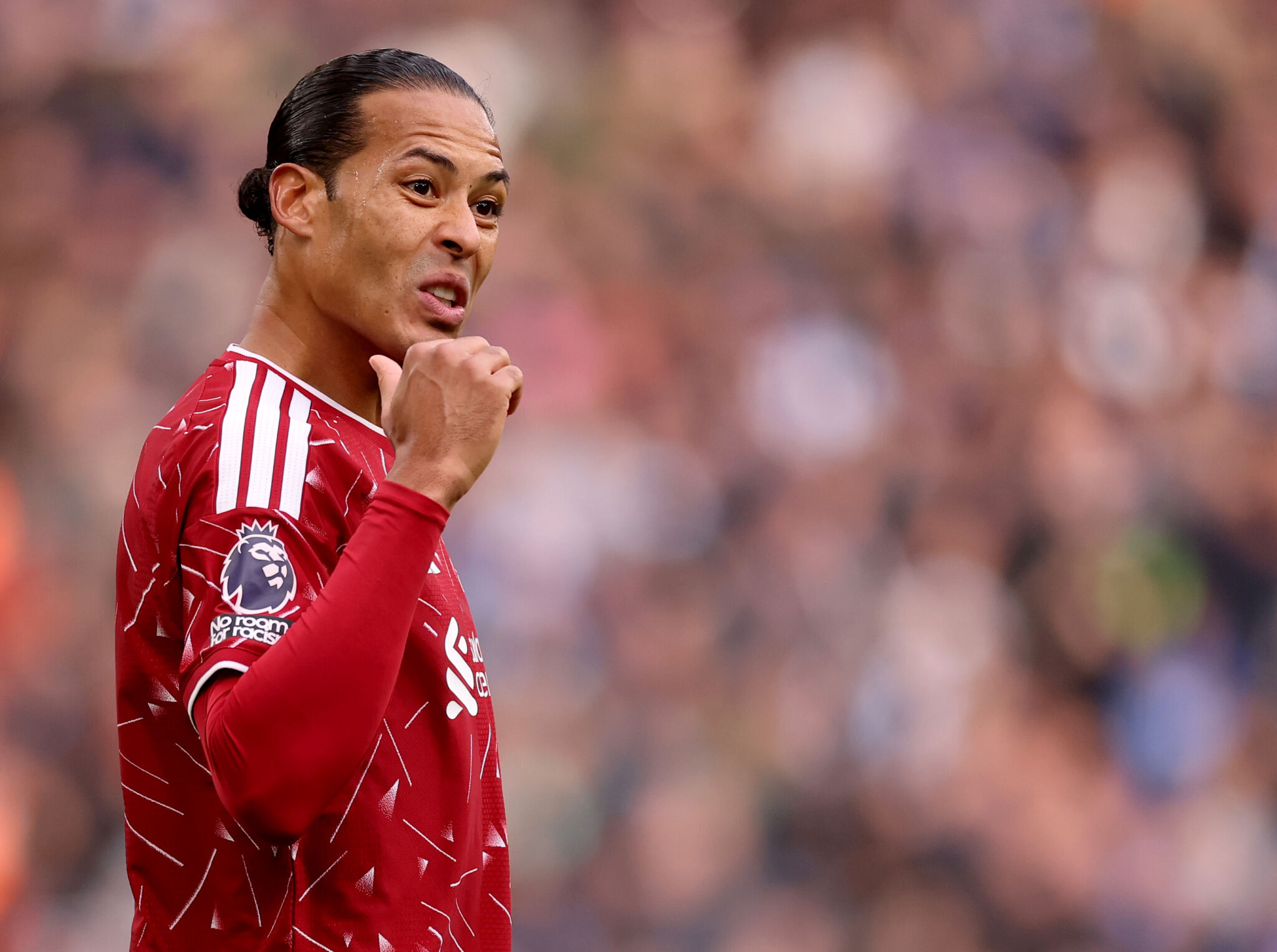 Virgil van Dijk gestures to his teammates during a Liverpool match