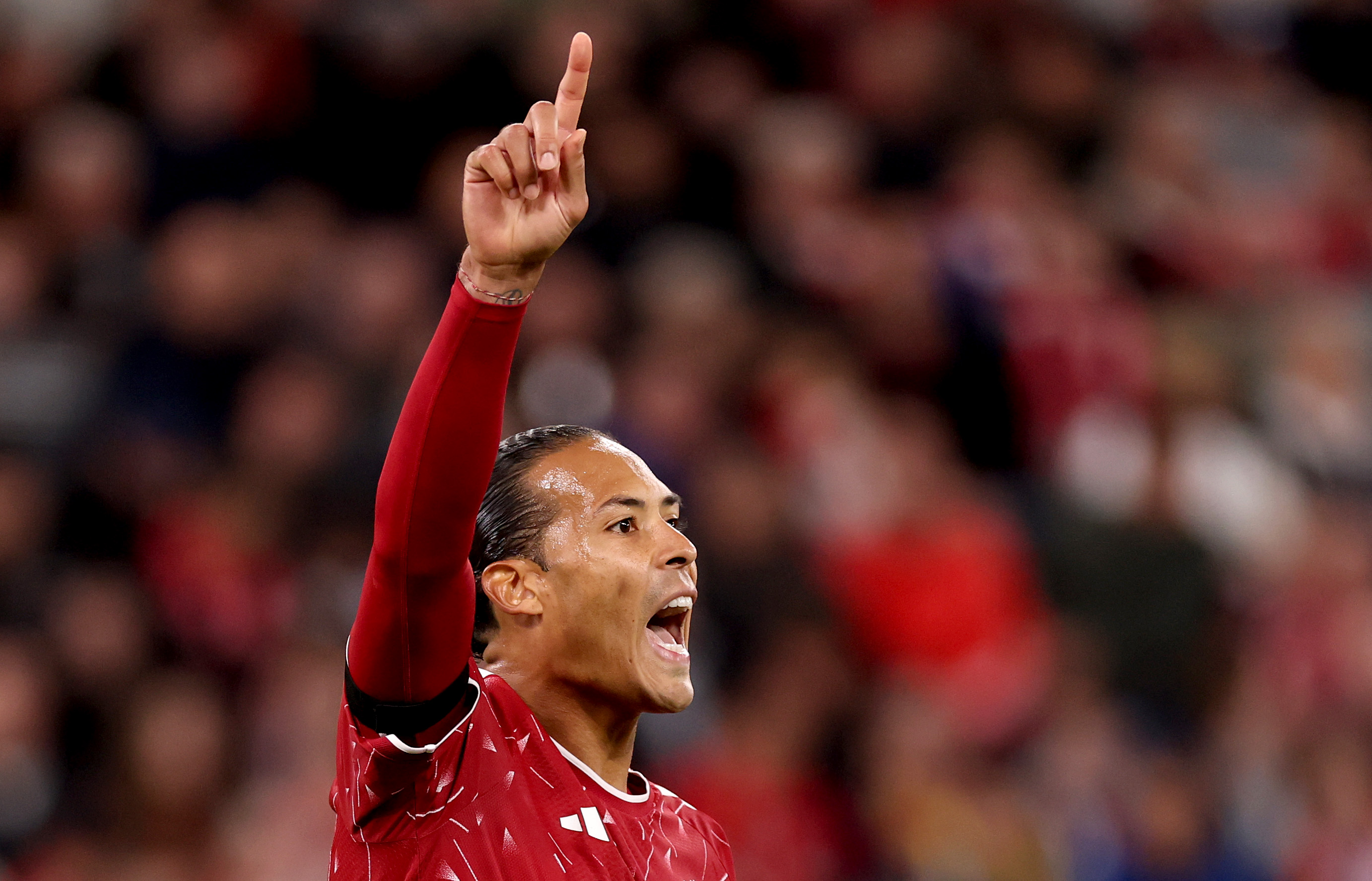 Virgil van Dijk shouts instructions to his Liverpool teammates