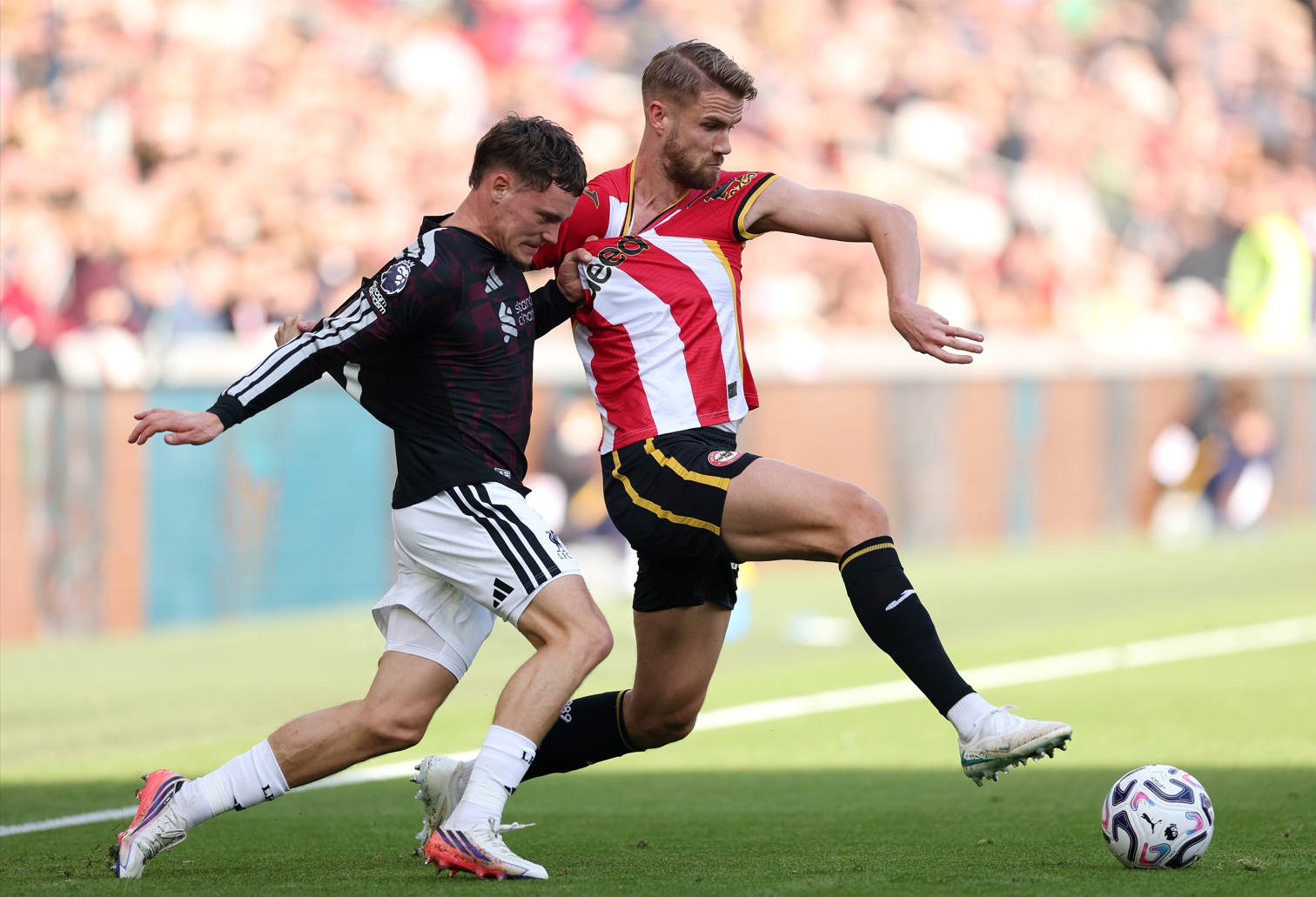 Florian Wirtz and Kristoffer Ajer battle for possession in Liverpool's win over Brentford